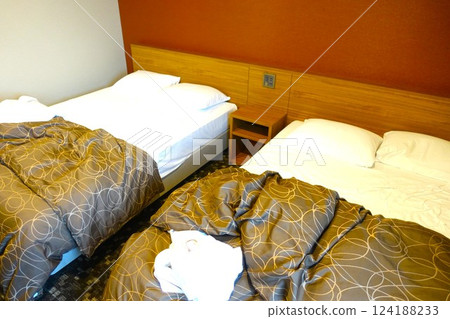Messy hotel bed at checkout 124188233