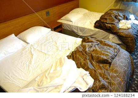 Messy hotel bed at checkout 124188234