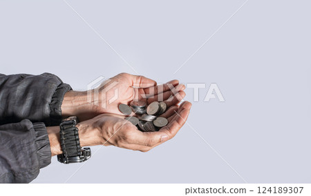 Hands with several coins in isolated background, Close up of hand with several coins, currency savings concept Hands with several coins in isolated background, Close up of hand with several coins, currency savings concept 124189307