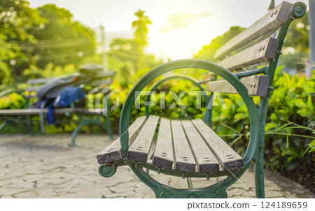Wooden bench with blur background with copy space. low angle view of a bench in a park, low angle view of a lonely bench in the park with out of focus background Wooden bench with blur background with copy space. low angle view of a bench in a park, low angle view of a lonely bench in the park with out of focus background 124189659