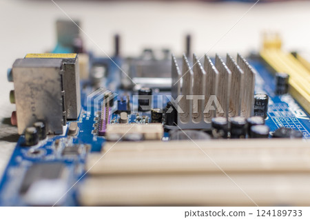 Close up of a motherboard, details of a computer motherboard, detail of a motherboard socket, three processors on a computer motherboard 124189733