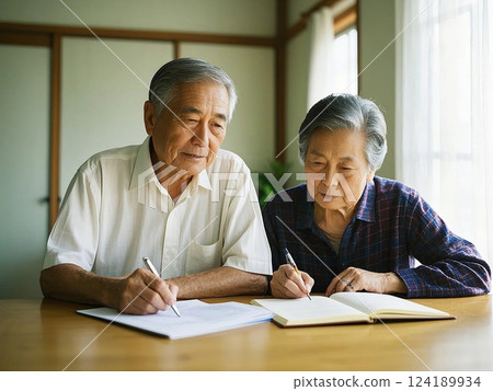 An elderly couple is writing documents 124189934
