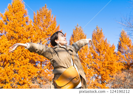 Woman enjoying autumn leaves lifestyle image Woman enjoying autumn leaves lifestyle image 124190212