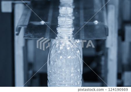 The  empty drinking water bottles  on the conveyor belt for filling process in the light blue scene. 124190989