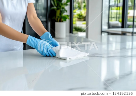 Woman Cleaning Kitchen Countertop Wearing Blue Gloves Woman Cleaning Kitchen Countertop Wearing Blue Gloves 124192156