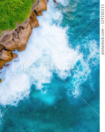 Aerial View of Waves Crashing on Rocky Coastline 124192213
