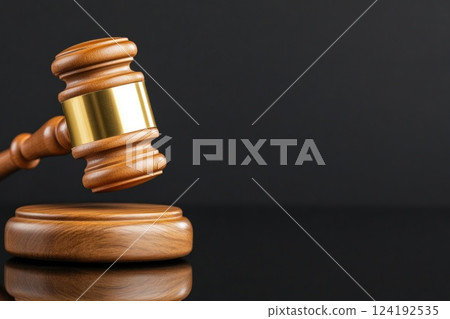Wooden and gold judge's gavel close-up 124192535