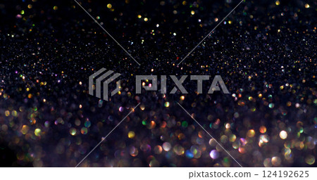 Sparkling shimmer. Shiny flare. Defocused golden blue purple color glitter celebration effect on dark black festive art background. Sparkling shimmer. Shiny flare. Defocused golden blue purple color glitter celebration effect on dark black festive art background. 124192625
