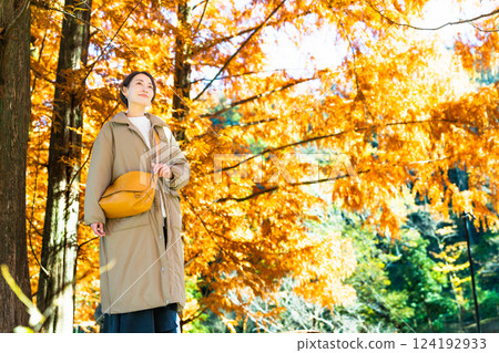 Woman enjoying autumn leaves lifestyle image Woman enjoying autumn leaves lifestyle image 124192933