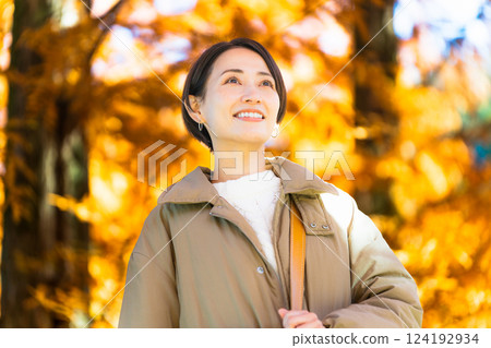 Woman enjoying autumn leaves lifestyle image Woman enjoying autumn leaves lifestyle image 124192934