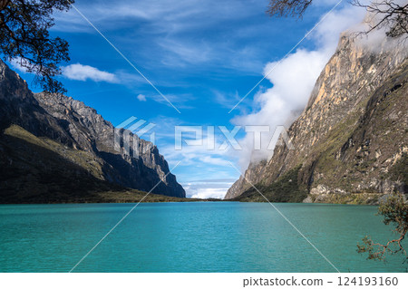 Turquoise lake surrounded by mountains on the Laguna 69 trek, Peru 124193160