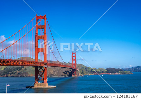 Golden Gate Bridge over blue waters with scenic hills in San Francisco Golden Gate Bridge over blue waters with scenic hills in San Francisco 124193167