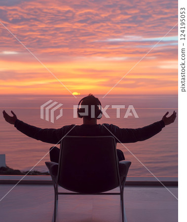 a young black man with headset joyfully on beach , stretching his arms . focused on the open space, allowing for additional visuals. 124195053