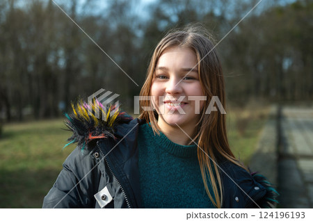 Teenage girl in spring park. Cute young girl outdoors. Beautiful teenage girl portrait 124196193