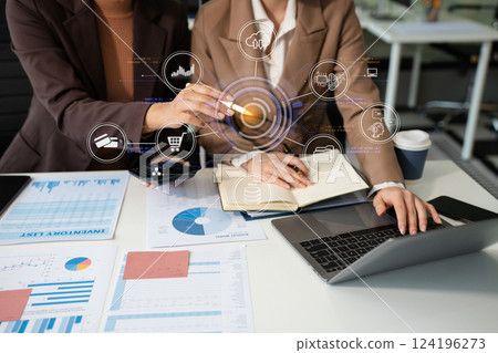 Businessmen team or financial data analysts working with tablets and laptop computers and data graphs together. Plan to analyzing projects in the office. 124196273