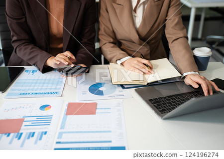 Businessmen team or financial data analysts working with tablets and laptop computers and data graphs together. Plan to analyzing projects in the office. 124196274