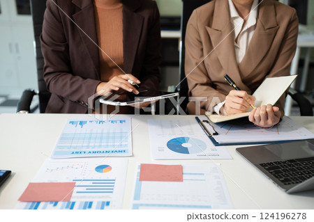 Businessmen team or financial data analysts working with tablets and laptop computers and data graphs together. Plan to analyzing projects in the office. Businessmen team or financial data analysts working with tablets and laptop computers and data graphs together. Plan to analyzing projects in the office. 124196278