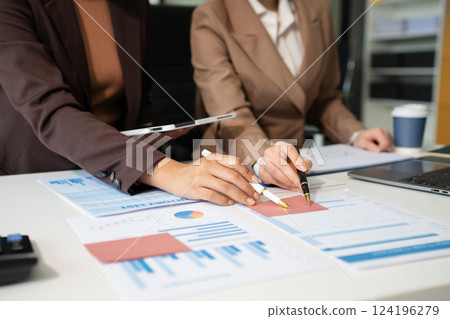 Businessmen team or financial data analysts working with tablets and laptop computers and data graphs together. Plan to analyzing projects in the office. 124196279