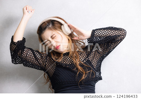 A young woman listening to music A young woman listening to music 124196433