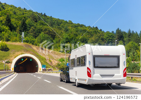 Scenic view big modern white family rv camper van vehicle drive Europe highway road alpine mountain cloud in summer day. Rving motorhome lifestyle travel and adventure tourism trip journey concept 124196572