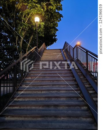 The staircase leading up, deserted at dusk surrounded by a tree, is beautiful and atmospheric The staircase leading up, deserted at dusk surrounded by a tree, is beautiful and atmospheric 124196659