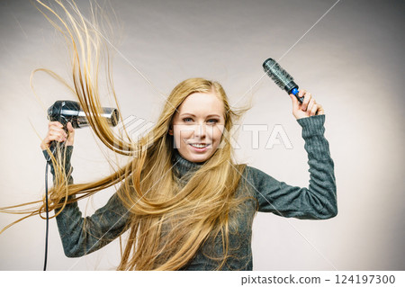 Girl holds hair accessories, styling hair 124197300
