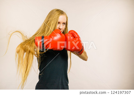Woman in gloves playing sports boxing Woman in gloves playing sports boxing 124197307