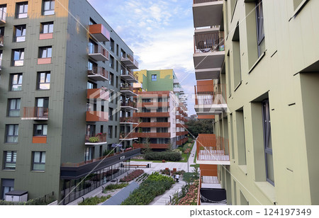 A row of apartment buildings with balconies. 124197349