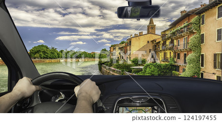 Driving a car towards Adige River in Verona, Italy 124197455