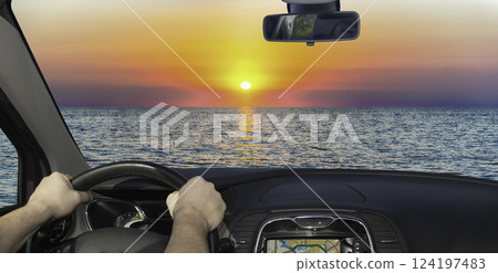 Driving towards a scenic sunset on the mediterranean sea 124197483