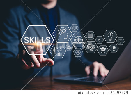 Skills Development and Business Learning Concept. A professional interacts with a virtual "Skills" interface, icons representing learning, growth, teamwork, innovation, and success in business. 124197579