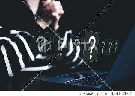 Question Marks and Problem Solving Concept. A person sits in front of laptop, surrounded by floating question mark icons, symbolizing inquiry, decision-making, and problem-solving in digital context. 124197607