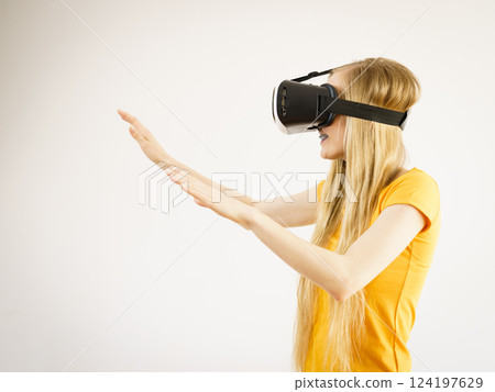 Girl wearing virtual reality goggles. Girl wearing virtual reality goggles. 124197629