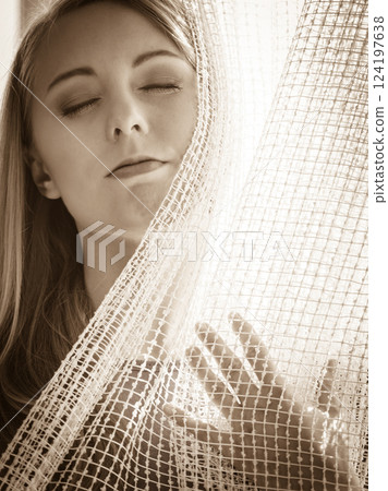 Woman relaxing on windowsill 124197638