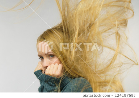 Sad girl with blowing hair Sad girl with blowing hair 124197695