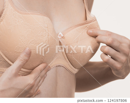 Girl wearing too big bra cup Girl wearing too big bra cup 124197806