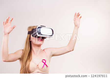 Girl in bra pink cancer ribbon and vr box 124197811