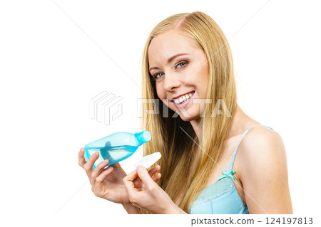 Woman using cleanser cosmetic Woman using cleanser cosmetic 124197813