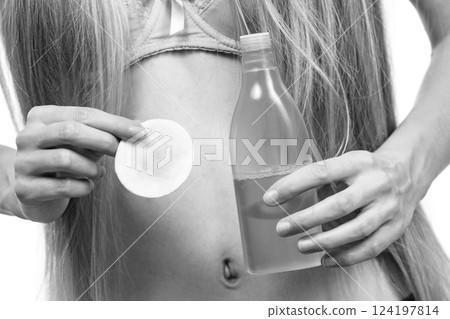 Woman using cleanser cosmetic Woman using cleanser cosmetic 124197814