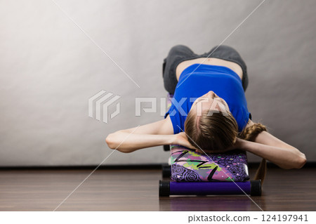 Woman training on bench for sit ups 124197941