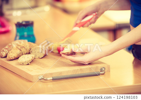 Woman preparing healthy breakfast making sandwich 124198103