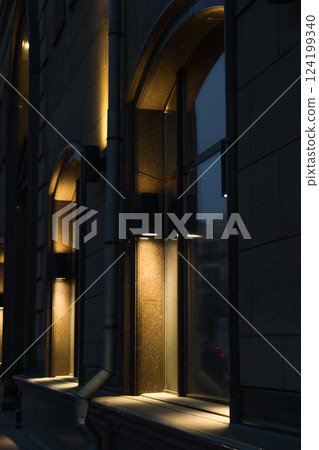 Illumination of the granite-marble facade of the old building late at night Illumination of the granite-marble facade of the old building late at night 124199340