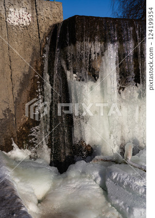 Frozen waterfall water. A frozen waterfall on a February morning 124199354