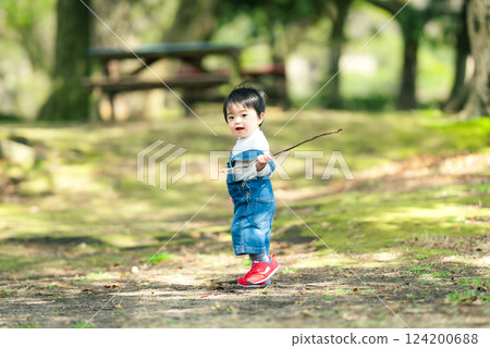 1 year old boy playing in the park 124200688