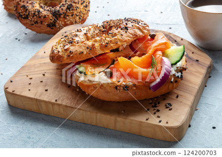 Lox bagel. A sandwich with smoked salmon and fresh vegetables Lox bagel. A sandwich with smoked salmon and fresh vegetables 124200703