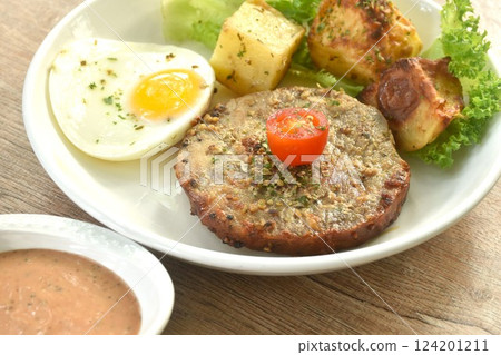 grilled black pepper pork collor steak and lettuce with tomato couple fried egg on plate dipping gravy sauce in cup 124201211
