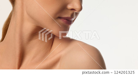 Cropped image of female face, neck and bare shoulders, young woman with glowing skin, emphasizing neck and jawline beauty. Cropped image of female face, neck and bare shoulders, young woman with glowing skin, emphasizing neck and jawline beauty. 124201325
