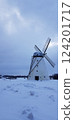 Old white windmill on winter field 124201717