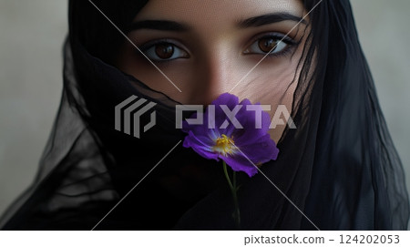 A woman wearing a black veil with a purple flower 124202053