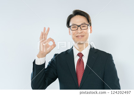 Businessman looking at the camera and saying OK 124202497